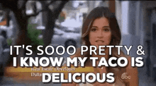 a woman is holding a taco and saying `` it 's sooo pretty and i know my taco is delicious ''