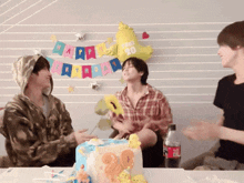 a group of young men are celebrating a birthday with a cake with the number 20 on it