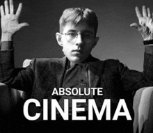 a black and white photo of a man with glasses and the words absolute cinema below him