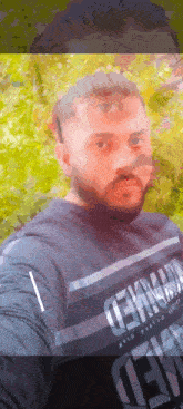 a man with a beard is wearing a shirt that says tekno on it