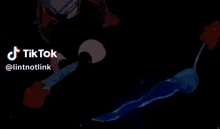 a person is holding a sword in their hand in a video that says tiktok .
