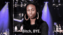 a woman wearing hoop earrings says bitch bye