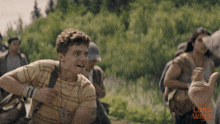 a group of people running in a field with the long walk written on the bottom right
