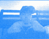 a blue and white pixelated image of a person holding a camera