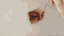 a painting of a woman 's face is being painted with a made in animatica logo