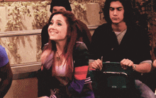 a girl with red hair is smiling in a crowd