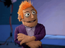 a puppet with orange hair is wearing a purple jacket and white shirt