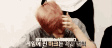 a man with red hair is being brushed by a woman .