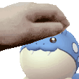 a person is petting a blue and white cartoon animal .
