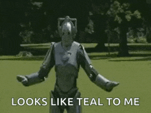 a robot is standing in a field with the words `` looks like teal to me '' written on it .
