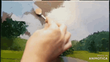 a person is painting a landscape on a canvas with the words made in animotica below them
