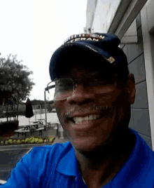 a man wearing a blue shirt and a hat that says ' columbia ' on it