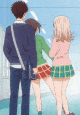 a man carrying a blue messenger bag stands between two girls