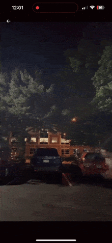 a phone screen shows a blurred image of a person running in a parking lot