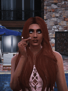 a woman with red hair is standing in front of a pool
