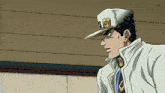 a man wearing a white jacket and a white hat with a gold letter o on it