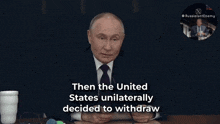 a man in a suit and tie talks about the agreement