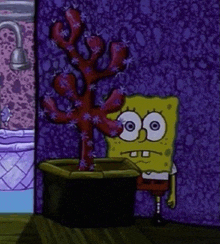spongebob squarepants is standing next to a potted plant in a room .