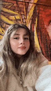 a young woman in front of a wall with graffiti on it