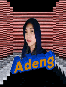 a woman in a blue hoodie is standing in front of a blue adeng sign