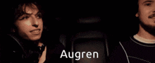 two men are sitting in a car and the word augren is on the screen