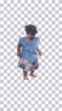 a little girl in a blue dress is jumping in the air against a checkered background