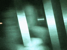 a blurred image of a person 's hand holding a light in a dark room