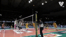 a volleyball game is being played on a court that has a banner that says ' volley ball ' on it