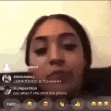 a woman is making a funny face while talking on a video call with a group of people .