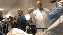 a group of people in a hospital hallway with hap pily written on the bottom right