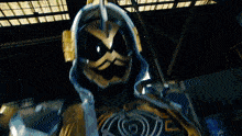 a close up of a superhero with a hood on his head