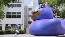a man in a superhero costume stands in front of a giant purple monster