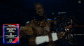 a man in a wrestling ring holding a championship belt and pointing