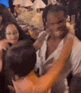 a man is hugging a woman at a party .