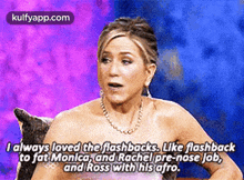 a woman is sitting on a couch with a purple background while talking about flashbacks .