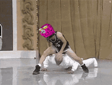 a person wearing a pink mask with the number 19 on it