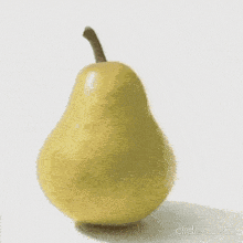 a yellow pear with a face cut out of it is on a white surface