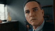 a close up of a man 's face with a serious look on his face