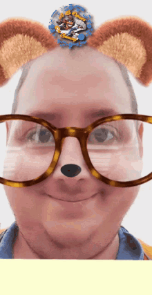 a man wearing glasses and bear ears with a picture of a bear on his head