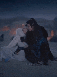 a couple sitting under a starry night sky