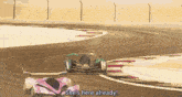 a pink and purple futuristic car is parked on the side of a road