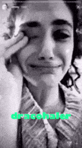 a black and white photo of a woman crying with the word dracohaler written below her