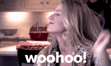 a woman in a kitchen with the word woohoo written on it