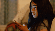 a girl is looking at her phone and making a surprised face