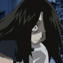 a close up of a person 's face with long black hair