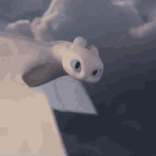 toothless from how to train your dragon 3 is flying through the air .