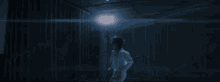 a person is laying on their back on the floor in a dark room