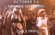 two women are dancing in front of a crowd at a girls trip .