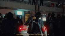 a blurred image of a group of people with one saying tyo khan
