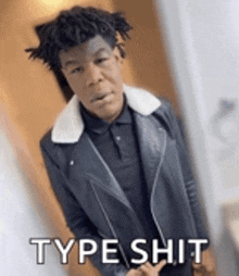 a young man wearing a leather jacket and a polo shirt is standing in front of a door and says type shit .